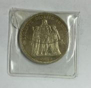 A French silver 5 Franc coin. Est. £15 - £20.