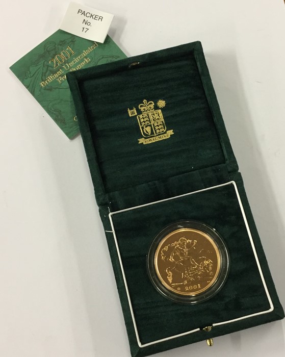 A Royal Mint cased proof 2001 £5 gold coin. Est. £