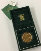 A Royal Mint cased proof 2001 £5 gold coin. Est. £