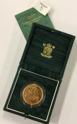 A Royal Mint cased proof 2001 £5 gold coin. Est. £