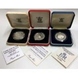 A proof silver Prince of Wales coin together with