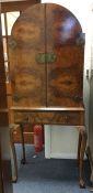 A walnut drink's cabinet with fitted interior. Est
