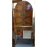 A walnut drink's cabinet with fitted interior. Est