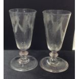 A pair of Georgian glass tapering goblets etched w