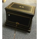 A good quality ebony and gilded drinks cabinet on