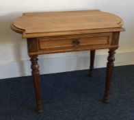 A Continental shaped top single drawer table on tu