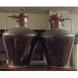 A pair of tall tapering copper urns with lift-off