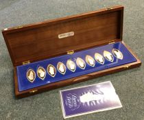 A cased set of eight silver medallions depicting '
