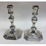 A good pair of George I style cast silver candlest