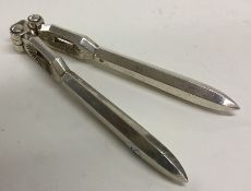 A heavy pair of Continental silver nut crackers wi