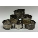 A bag containing six silver engraved napkin rings.