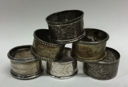 A bag containing six silver engraved napkin rings.