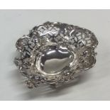 A small silver heart shaped pin dish with scroll d