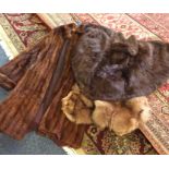 Three old fur coats. Est. £20 - £30.