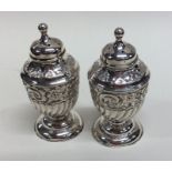 A pair of small half fluted silver sugar casters o