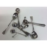 A bag containing numerous silver cruet spoons. App