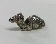A 20th Century figure of a silver seated camel wit