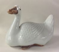 A Chinese figure of a seated goose with textured b