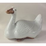 A Chinese figure of a seated goose with textured b