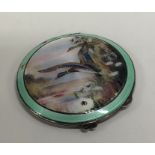 A silver and enamelled compact depicting ducks in