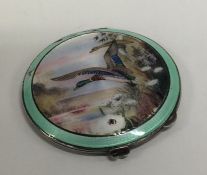 A silver and enamelled compact depicting ducks in