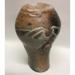 A baluster shaped stoneware pottery vase with lug