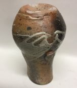 A baluster shaped stoneware pottery vase with lug