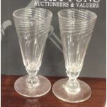 A pair of Antique swirl decorated tapering glass g