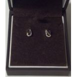 A pair of sapphire and diamond earrings contained