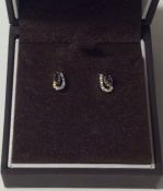 A pair of sapphire and diamond earrings contained