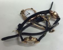 A group of three gold wristwatches on leather stra