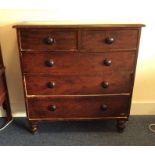 A large mahogany chest of five drawers on turned s