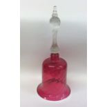 An Antique cranberry glass bell with tapering spir