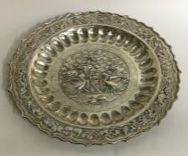 A circular Chinese silver dish decorated with bird