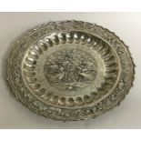 A circular Chinese silver dish decorated with bird