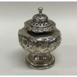 A Georgian silver chased baluster shaped pepper on