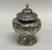 A Georgian silver chased baluster shaped pepper on