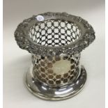 A silver plated wine coaster with embossed top and