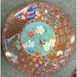 A large cloisonné wall charger decorated in bright