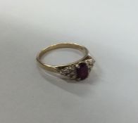A ruby and diamond thirteen stone cluster ring in