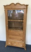 A Continental pine single door cabinet with shaped