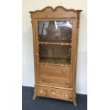A Continental pine single door cabinet with shaped