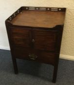 A Georgian mahogany two door commode with fretwork