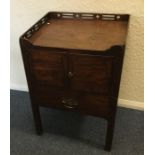 A Georgian mahogany two door commode with fretwork