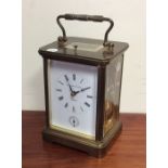 A large brass striking carriage clock with white e
