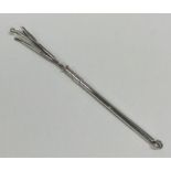 A silver swizzle stick of typical form. Approx. 7