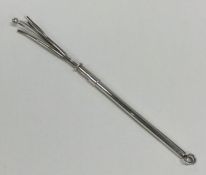 A silver swizzle stick of typical form. Approx. 7