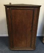 A Georgian oak corner cupboard. Est. £10 - £20.