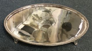 A large oval Georgian silver salver with bead work