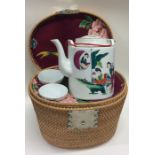 A cased tapering wicker tea service of Chinese des
